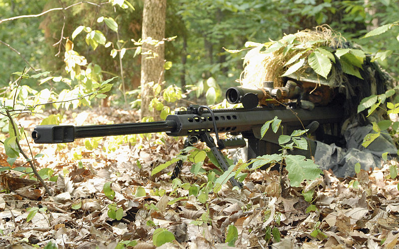 army sniper camouflaged in forest